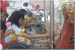 mujeres colocando incienso en un templo en Nakhon Si Thammarat